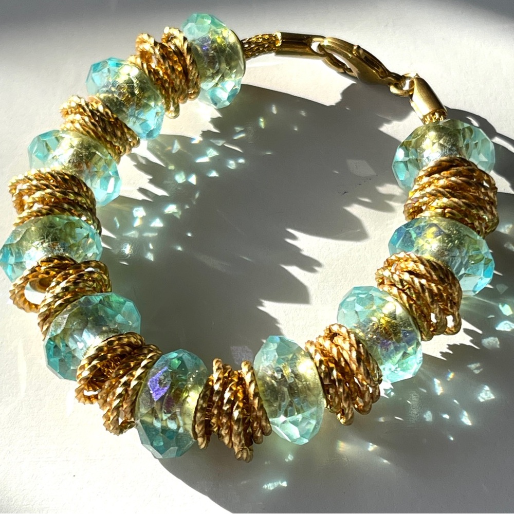 Vintage aqua blue AB faceted crystal rondelles with gold tone rings bracelet. 7”